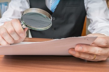 contract-businessman-magnifying-glass