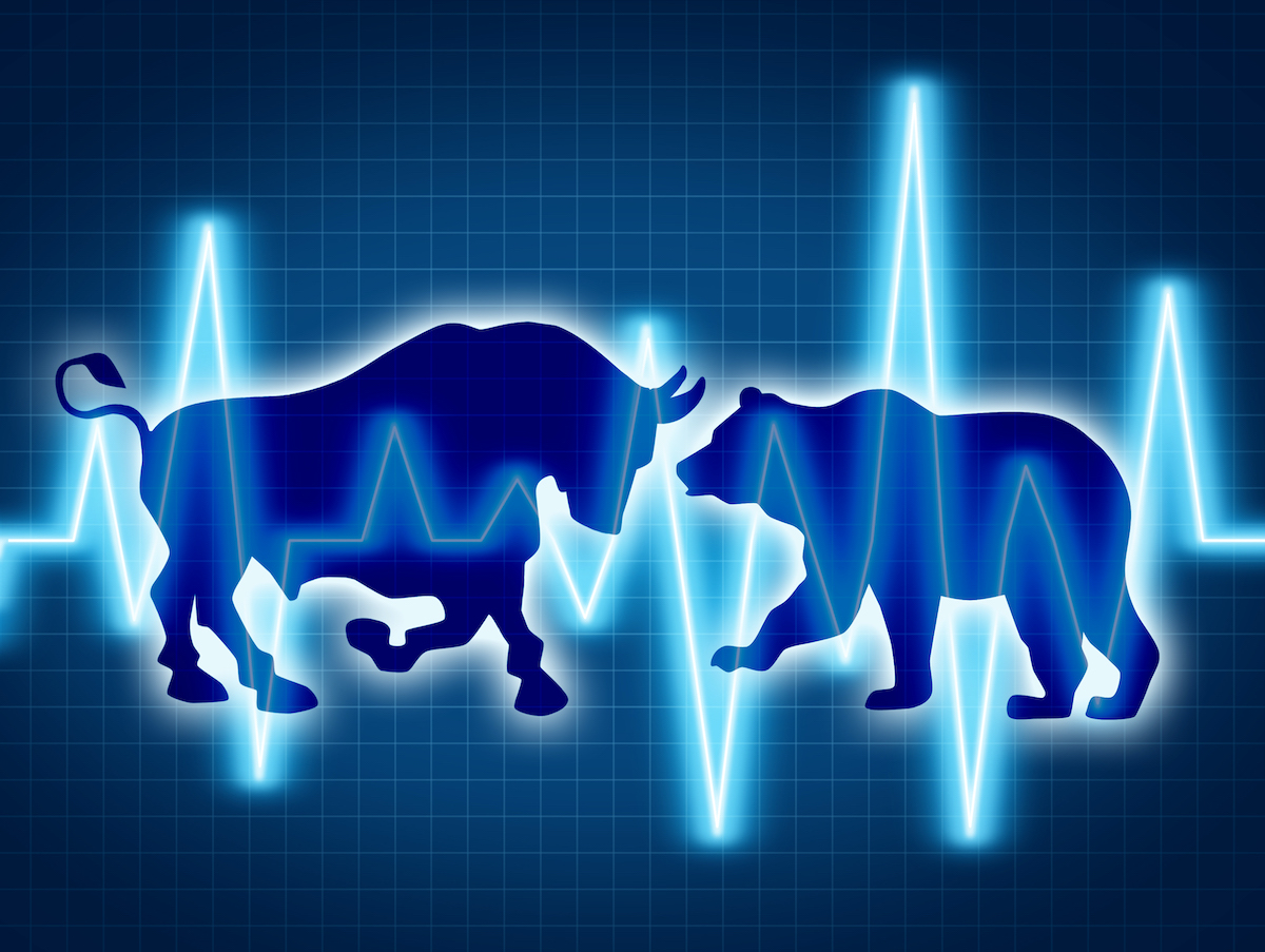 Trading and investing financial symbol with a two icons representing the bear and bull markets with a wire frame chart and ticker investing graph on a black background.